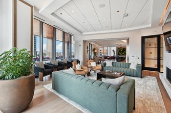 The lobby of a hotel with couches and chairs